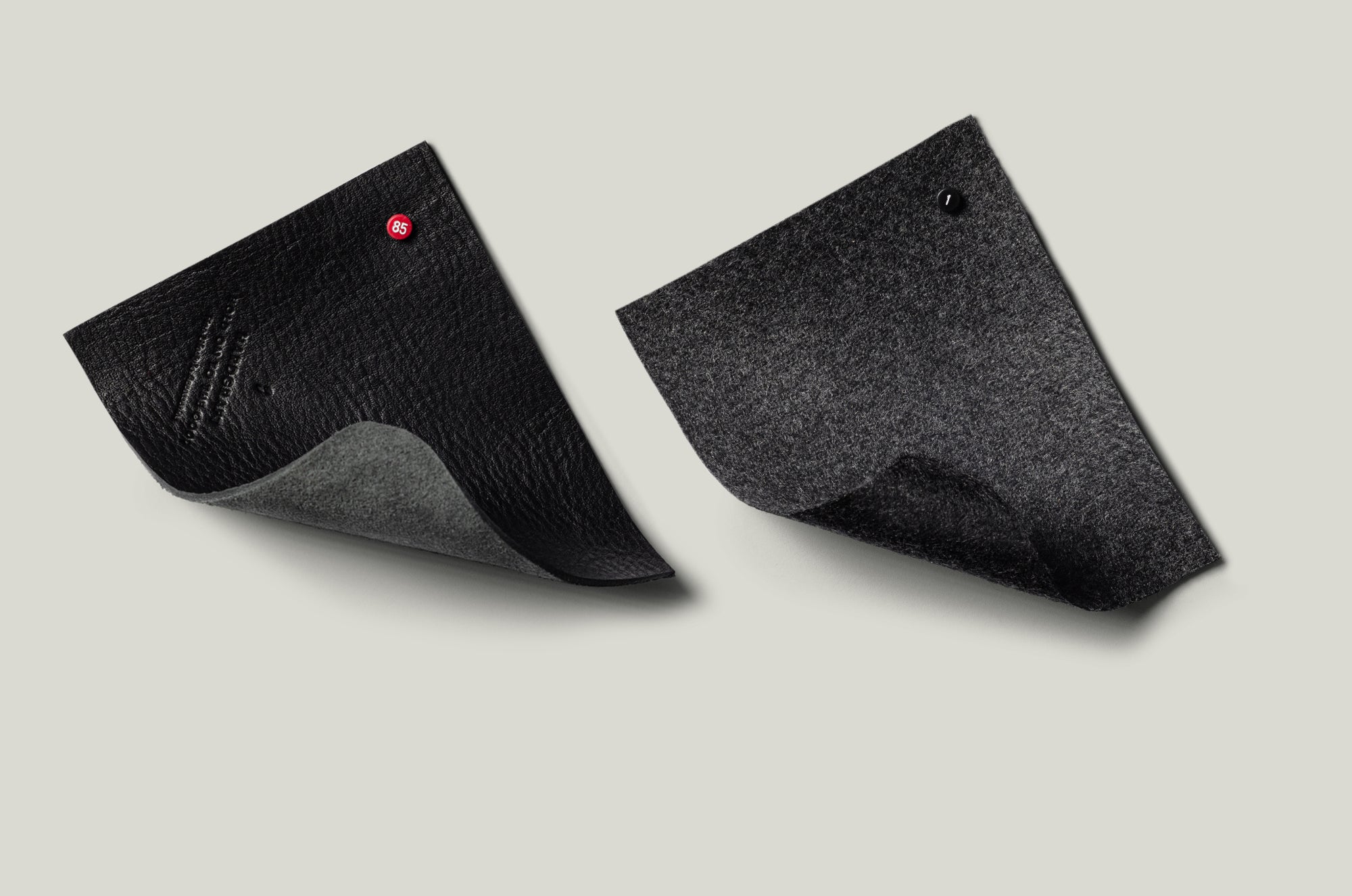 Black leather and grey wool swatches.