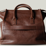 Brown leather bag on a light gray background