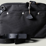 A charcoal-colored laptop bag with black leather straps and a brown wool-blend lining. It features a main compartment closed with a zipper and an additional exterior pocket.