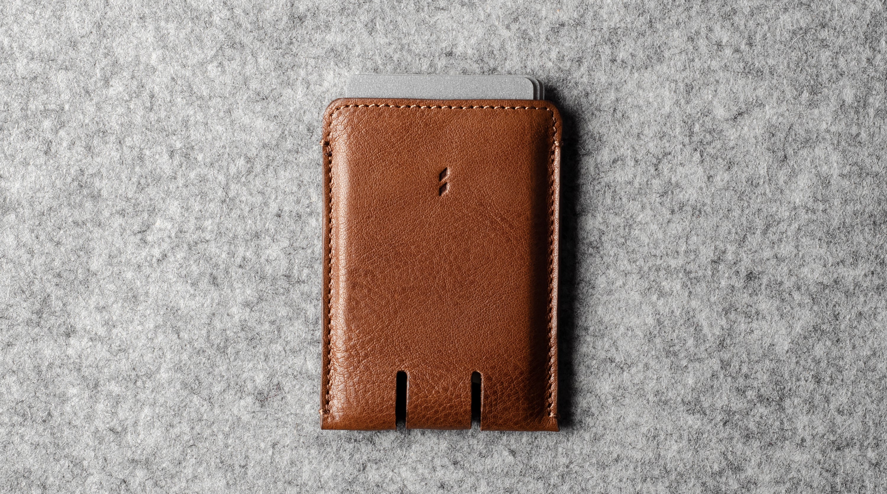 Brown leather wallet on a gray textured background