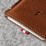 Brown leather phone case on a gray surface