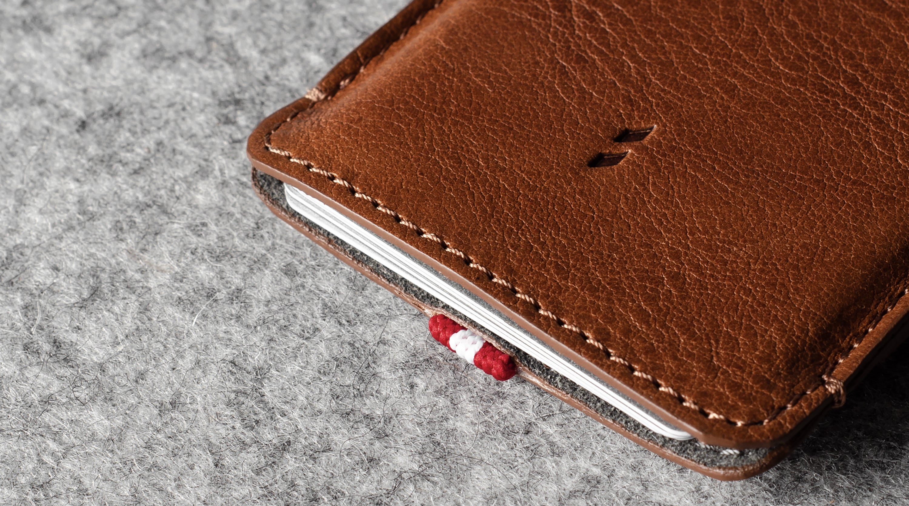 Brown leather phone case on a gray surface