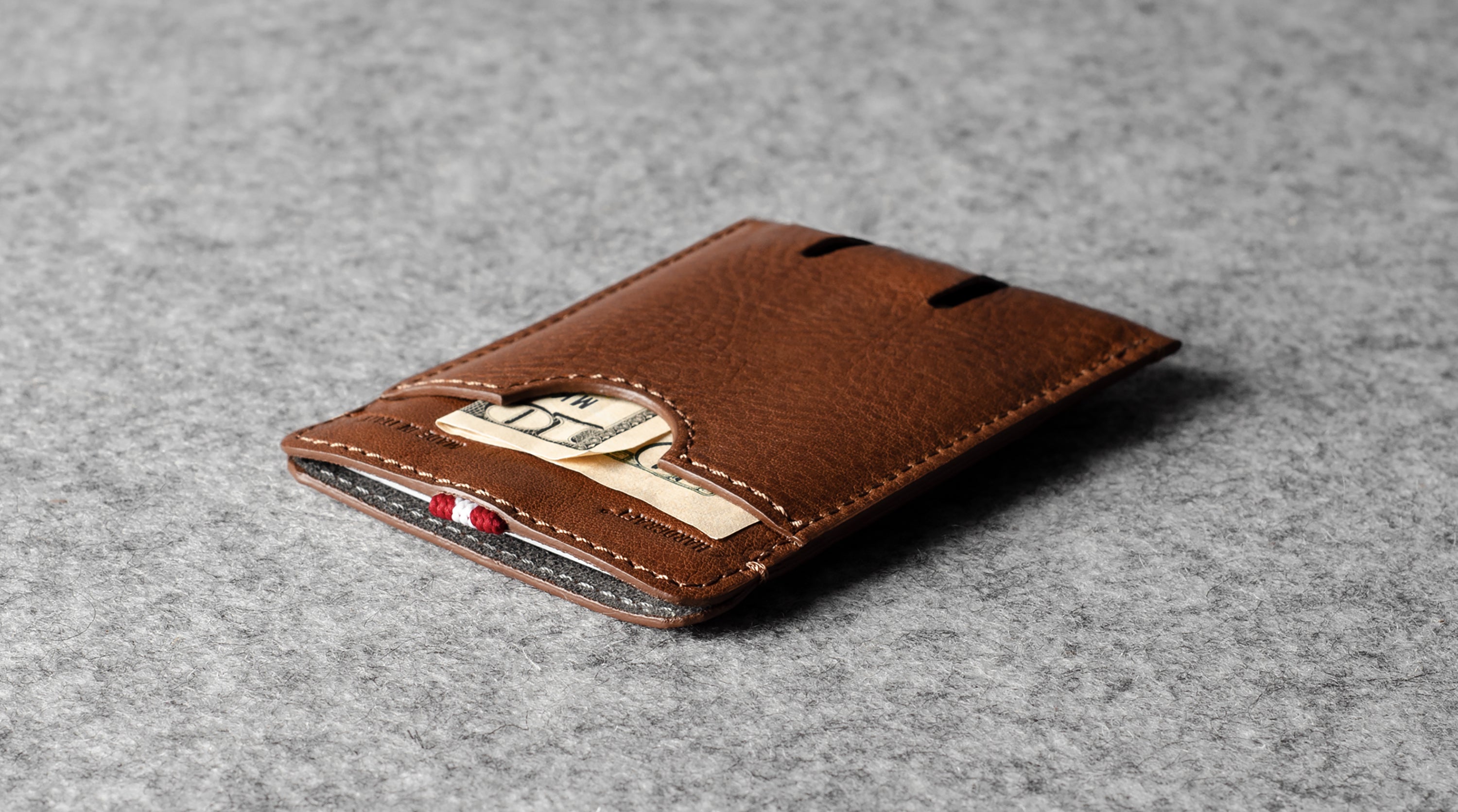 Brown leather wallet on a gray textured background