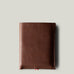 A brown leather iPhone Duo Case with a pebbled texture, shown closed against a solid light gray background.