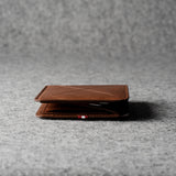 Brown leather wallet on a gray textured surface