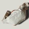 Beige waist cross body bag with technical fabric and brown leather details.