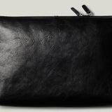 Black leather pouch with a zipper on a light gray background