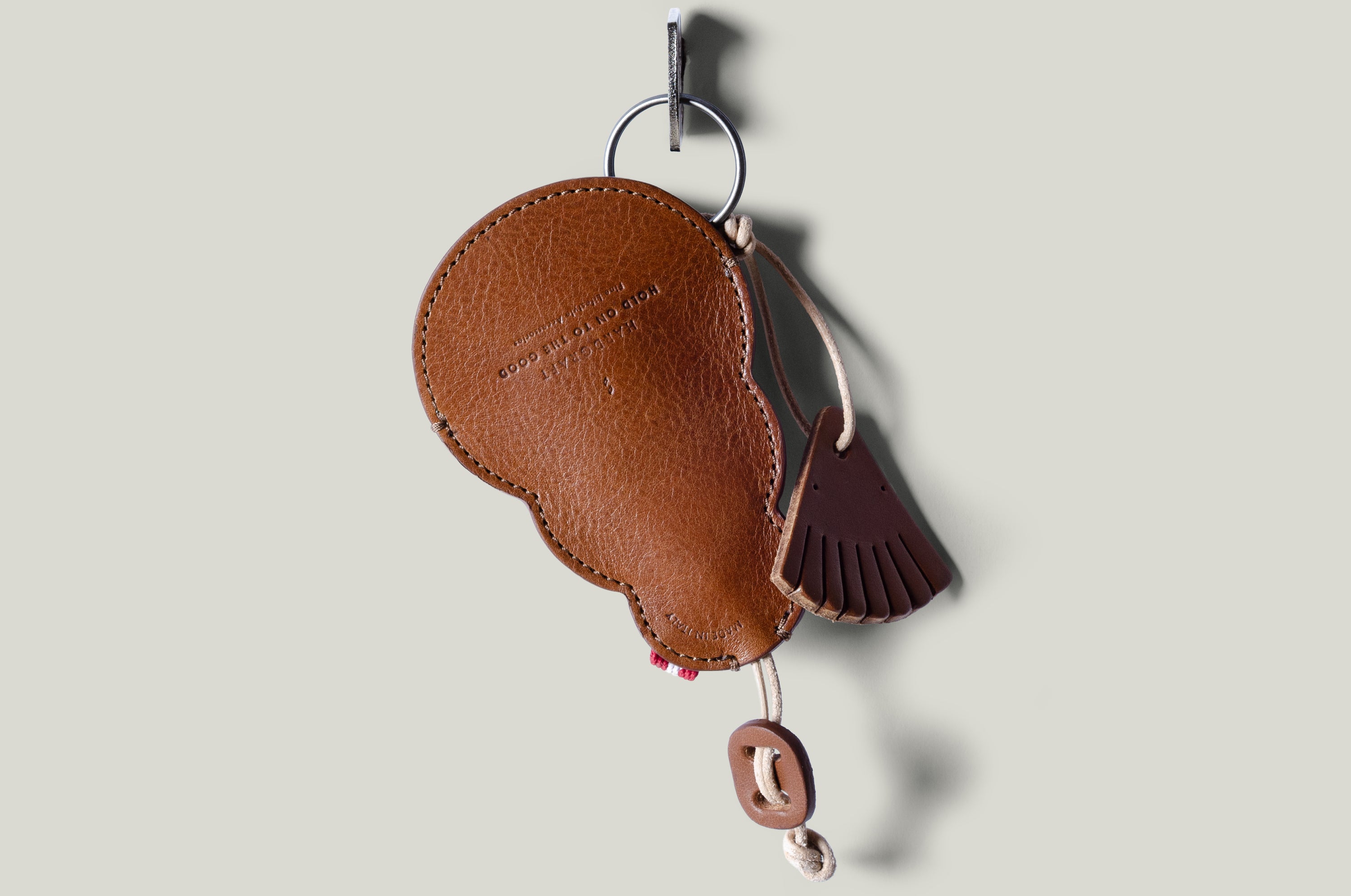 Brown leather keypouch on a light gray background