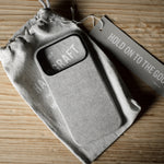 Gray iPhone case with 'Craft' branding on a wooden surface