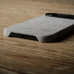 Gray iPhone case on a wooden surface