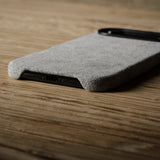 Gray iPhone case on a wooden surface