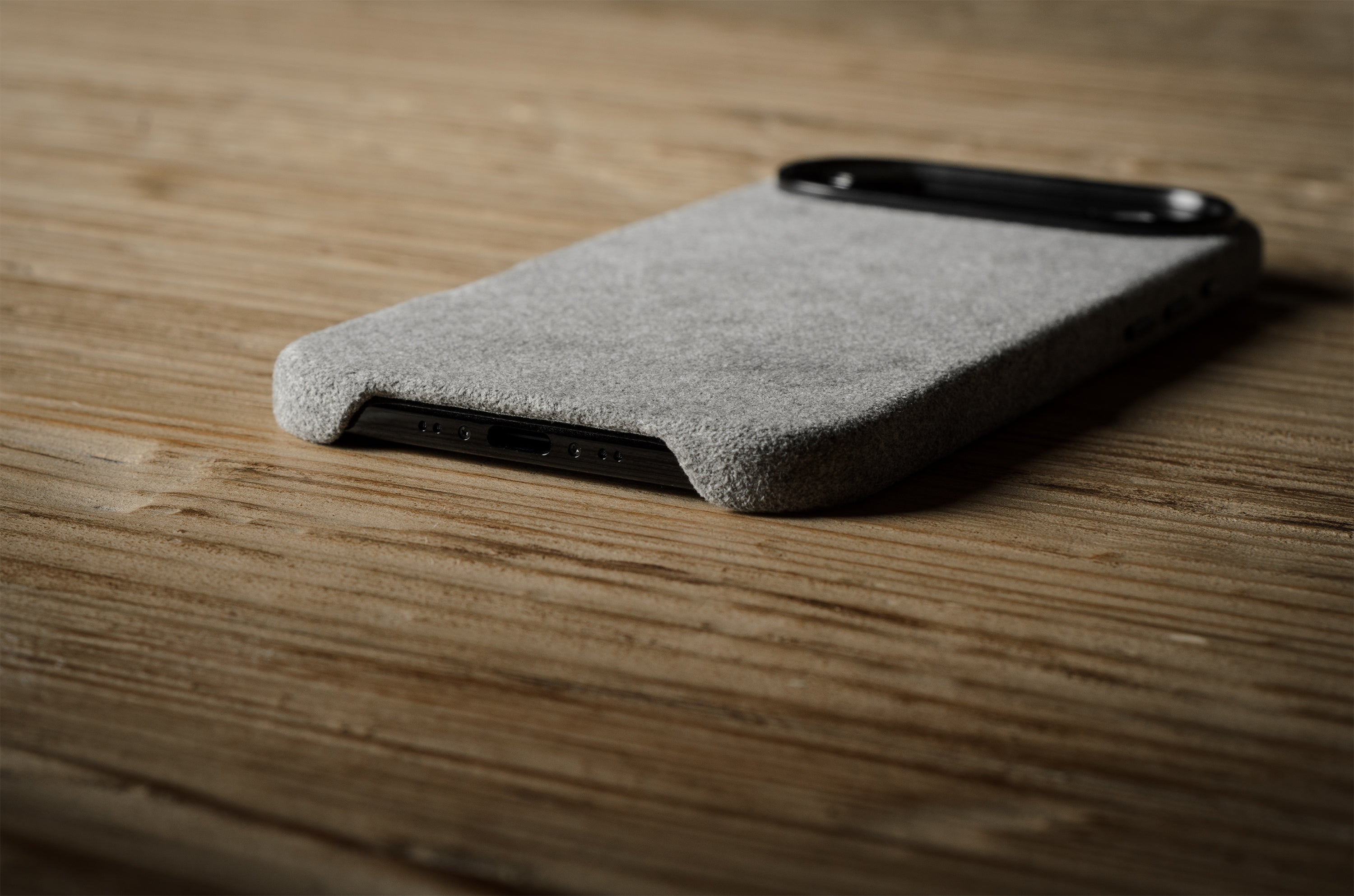 Gray iPhone case on a wooden surface