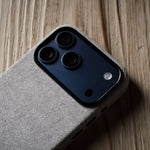 iPhone with a grey back cover on a wooden surface