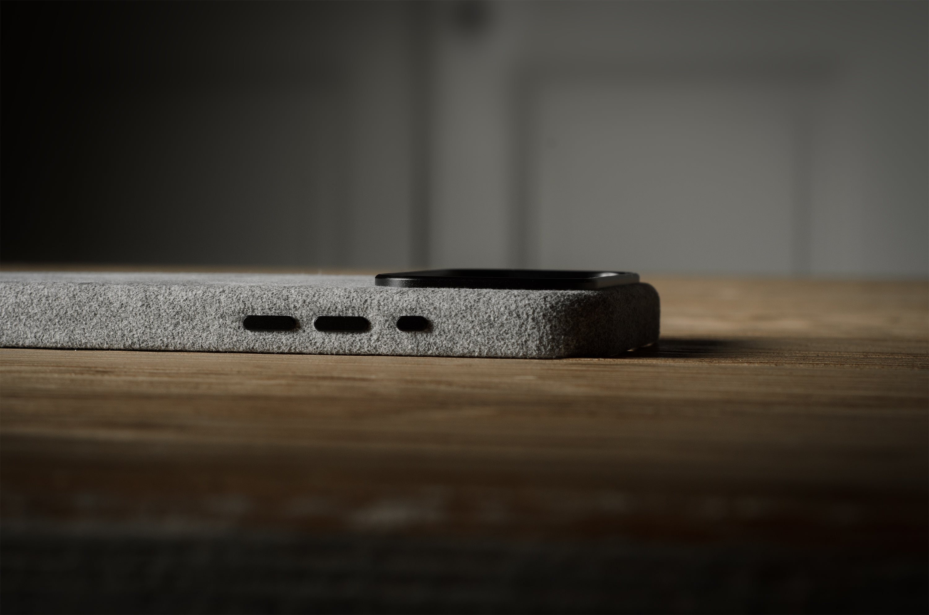 Close-up of a iPhone case on a wooden surface with a blurred background
