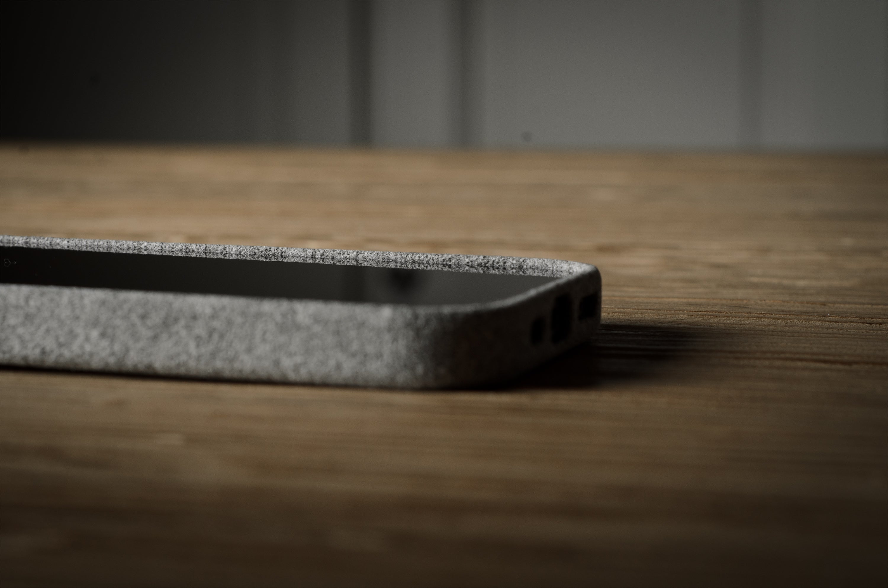 iPhone case with textured surface on a wooden surface