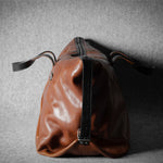 Brown leather bag on a gray textured background