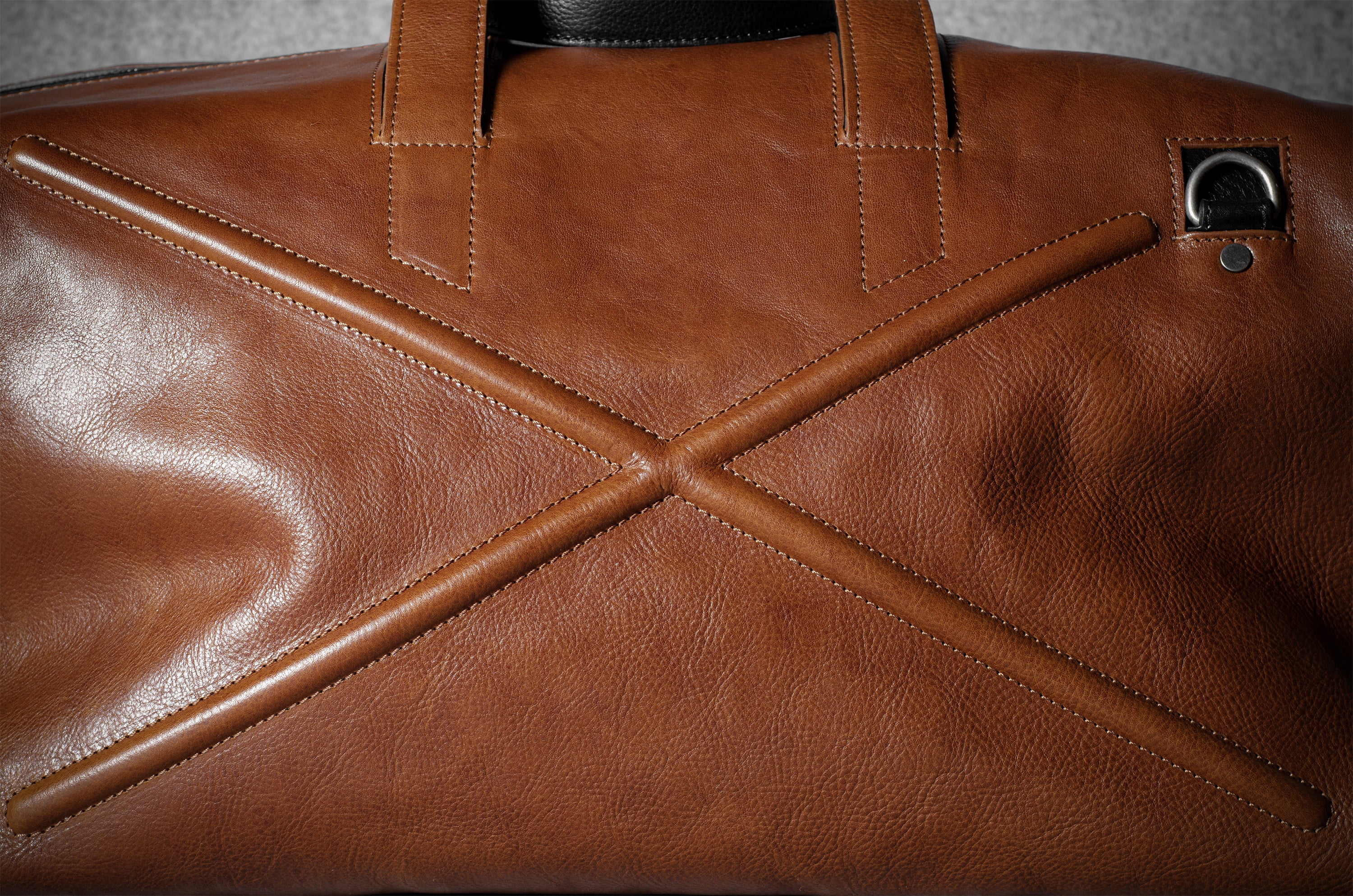 Close-up of a brown leather bag with geometric design