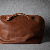 Brown leather bag on a gray background