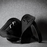 Black leather bag on a gray background