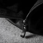 Close-up of a black zipper on a textured surface