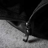 Close-up of a black zipper on a textured surface