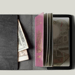 Black passport Case with passport on light background