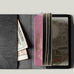 Black passport Case with passport on light background
