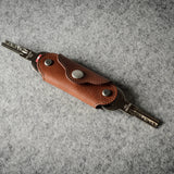 Multi-key pouch made of brown leather on a gray background